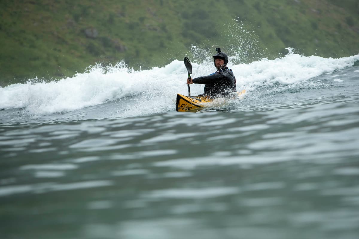 Sea kayak on a green wave face in Hoddevik