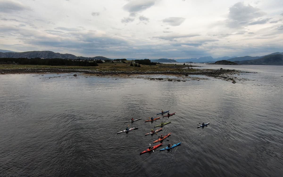 Course group in kayaks by an islet in Sunnmøre